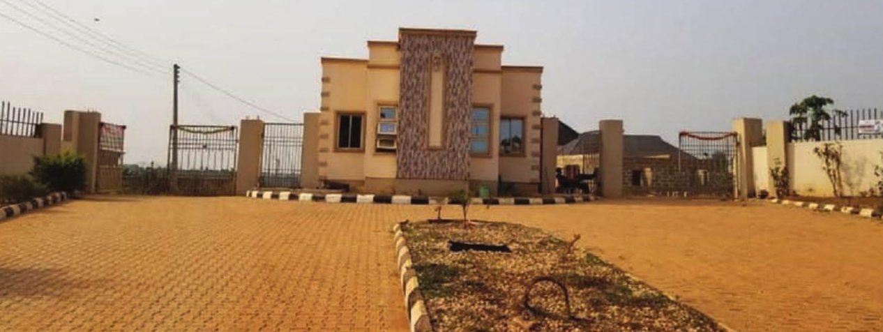 Entrance building and paved boulevard at Osun Country Homes